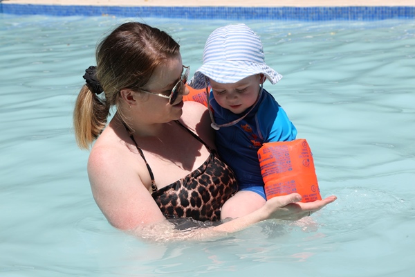 Image of child with floaties, correctly supervised by parent. Kids Health 